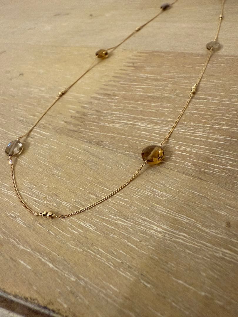 Agat K10 necklace with smoky quartz pendant displayed on white background with certificate and fabric pouch