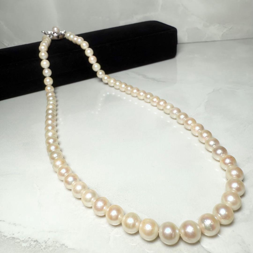 Okoya pearl necklace with pink pearls and silver clasp on white background