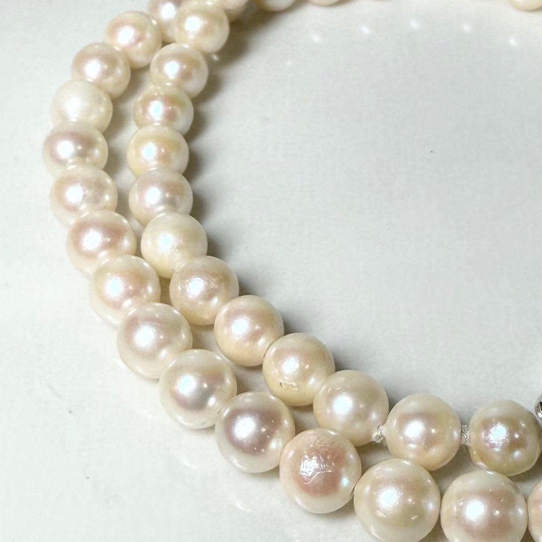 Okoya pearl necklace with pink pearls and silver clasp on white background