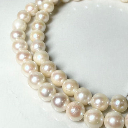 Okoya pearl necklace with pink pearls and silver clasp on white background