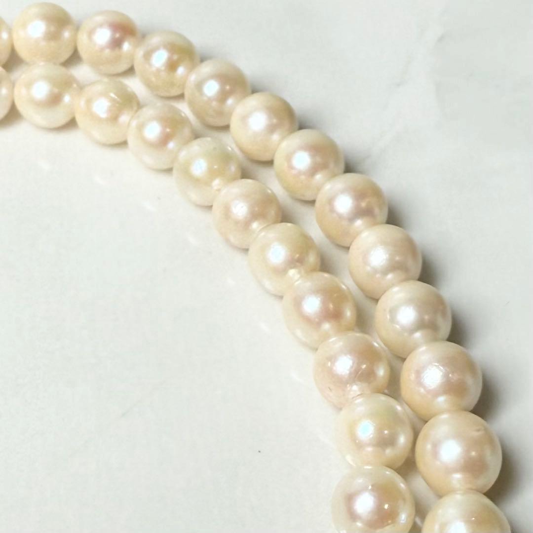 Okoya pearl necklace with pink pearls and silver clasp on white background