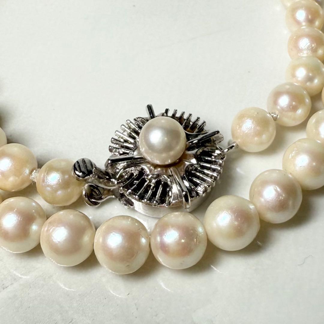 Okoya pearl necklace with pink pearls and silver clasp on white background