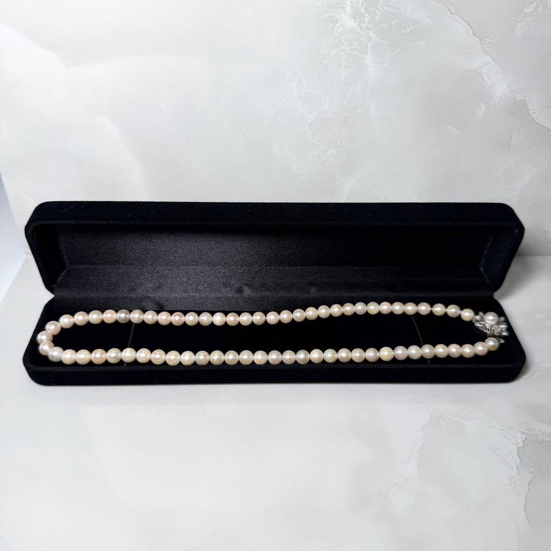Okoya pearl necklace with pink pearls and silver clasp on white background