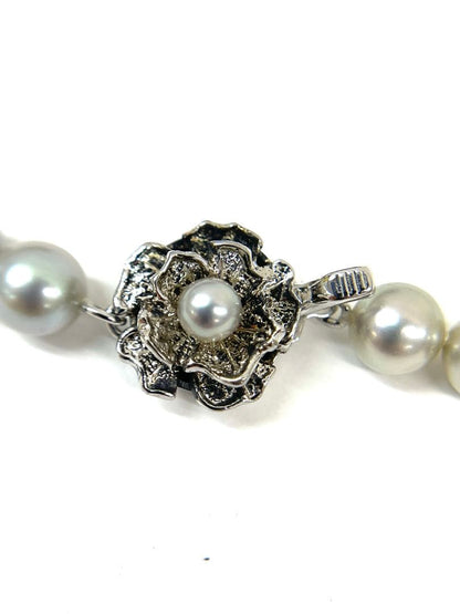 Camellia Akoya pearl necklace with 7.0-7.4mm pearls, single strand, and silver clasp on white background
