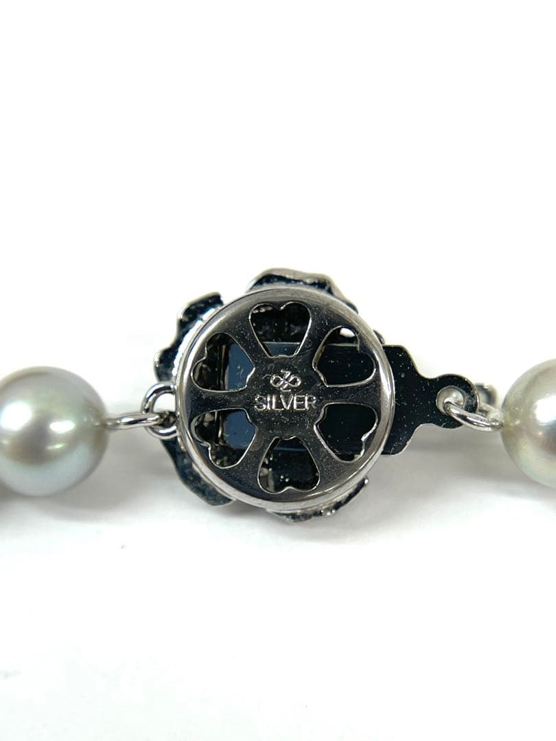 Camellia Akoya pearl necklace with 7.0-7.4mm pearls, single strand, and silver clasp on white background