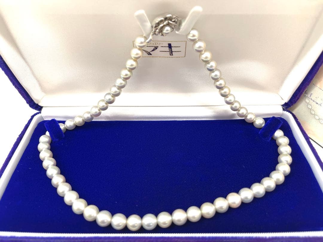 Camellia Akoya pearl necklace with 7.0-7.4mm pearls, single strand, and silver clasp on white background