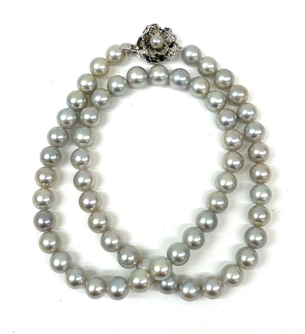 Camellia Akoya pearl necklace with 7.0-7.4mm pearls, single strand, and silver clasp on white background