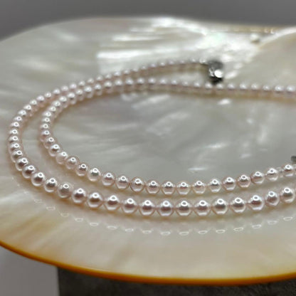 Akoya Pearl Pink Baby Pearl Necklace with white pink 3.5-4 mm pearls and 925 clasp on white background