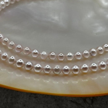 Akoya Pearl Pink Baby Pearl Necklace with white pink 3.5-4 mm pearls and 925 clasp on white background