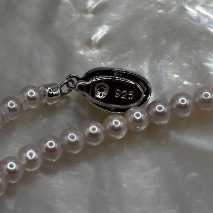 Akoya Pearl Pink Baby Pearl Necklace with white pink 3.5-4 mm pearls and 925 clasp on white background