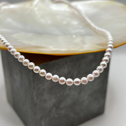 Akoya Pearl Pink Baby Pearl Necklace with white pink 3.5-4 mm pearls and 925 clasp on white background