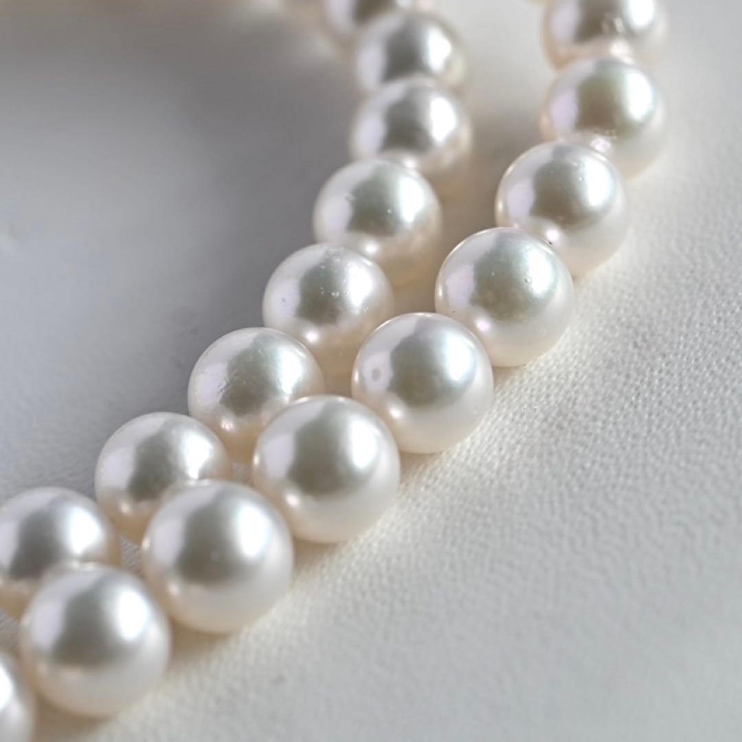 Takatsuki Akoya pearl necklace with 7.5mm round pearls and silver ribbon clasp on a white background