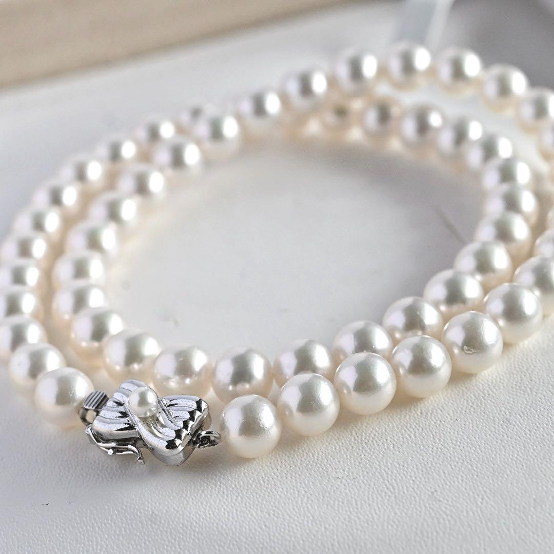 Takatsuki Akoya pearl necklace with 7.5mm round pearls and silver ribbon clasp on a white background