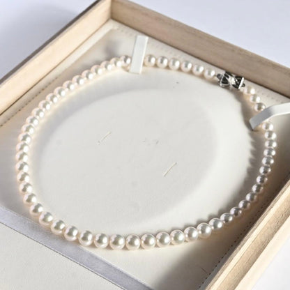 Takatsuki Akoya pearl necklace with 7.5mm round pearls and silver ribbon clasp on a white background