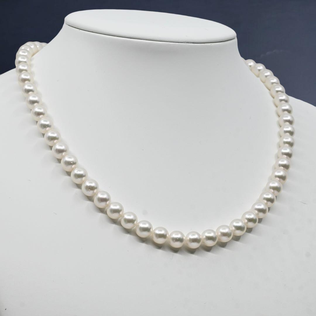 Takatsuki Akoya pearl necklace with 7.5mm round pearls and silver ribbon clasp on a white background