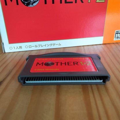 Game Boy Advance MOTHER1+2 game cartridge showing front label with visible signs of aging