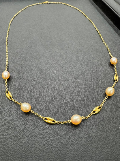 MIKIMOTO pearl necklace made of yellow 18K gold, 50 cm length, displayed on a white background