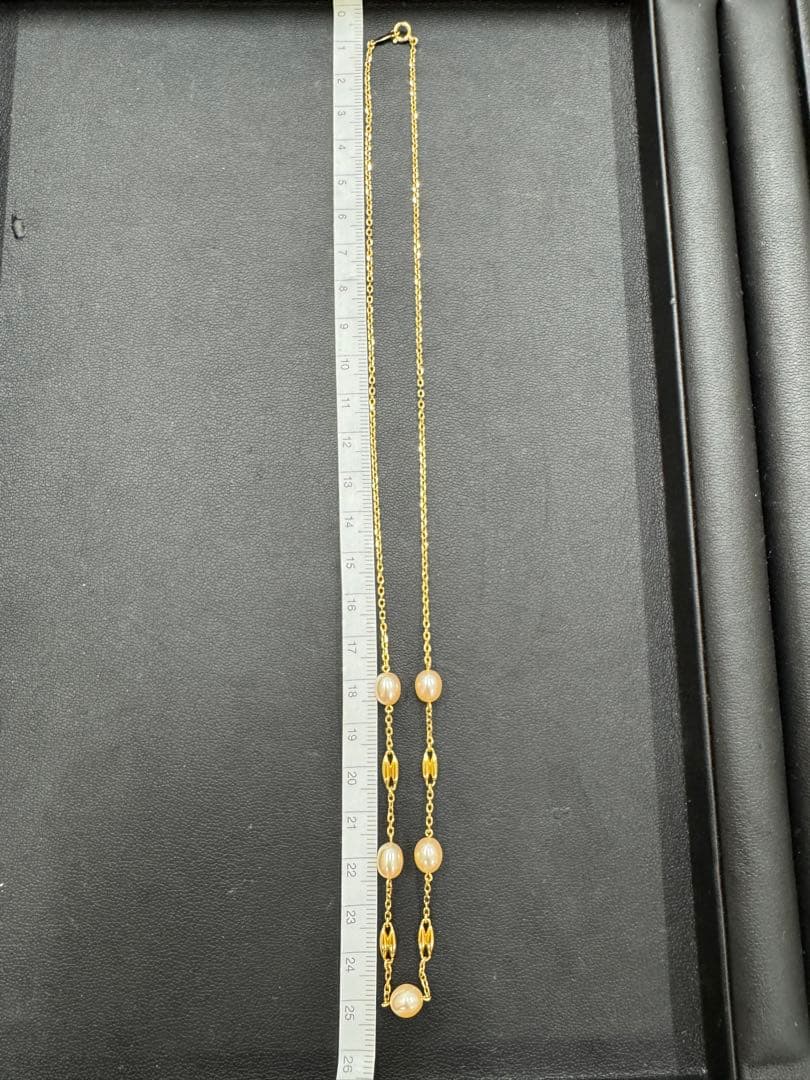MIKIMOTO pearl necklace made of yellow 18K gold, 50 cm length, displayed on a white background