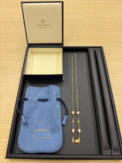 MIKIMOTO pearl necklace made of yellow 18K gold, 50 cm length, displayed on a white background