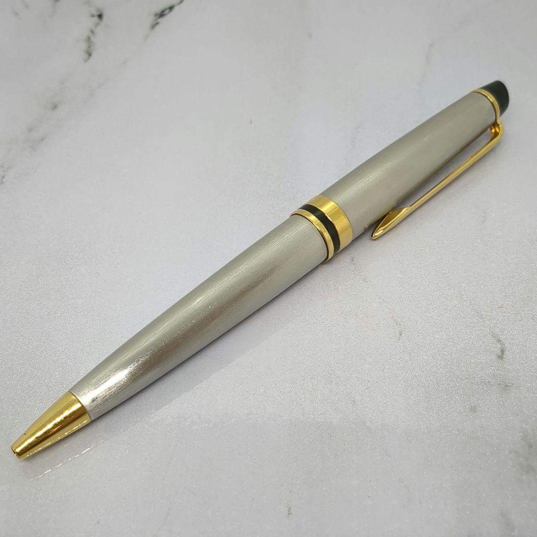 Waterman Expert ballpoint pen with steel satin finish and 23K gold trim, showing minor wear