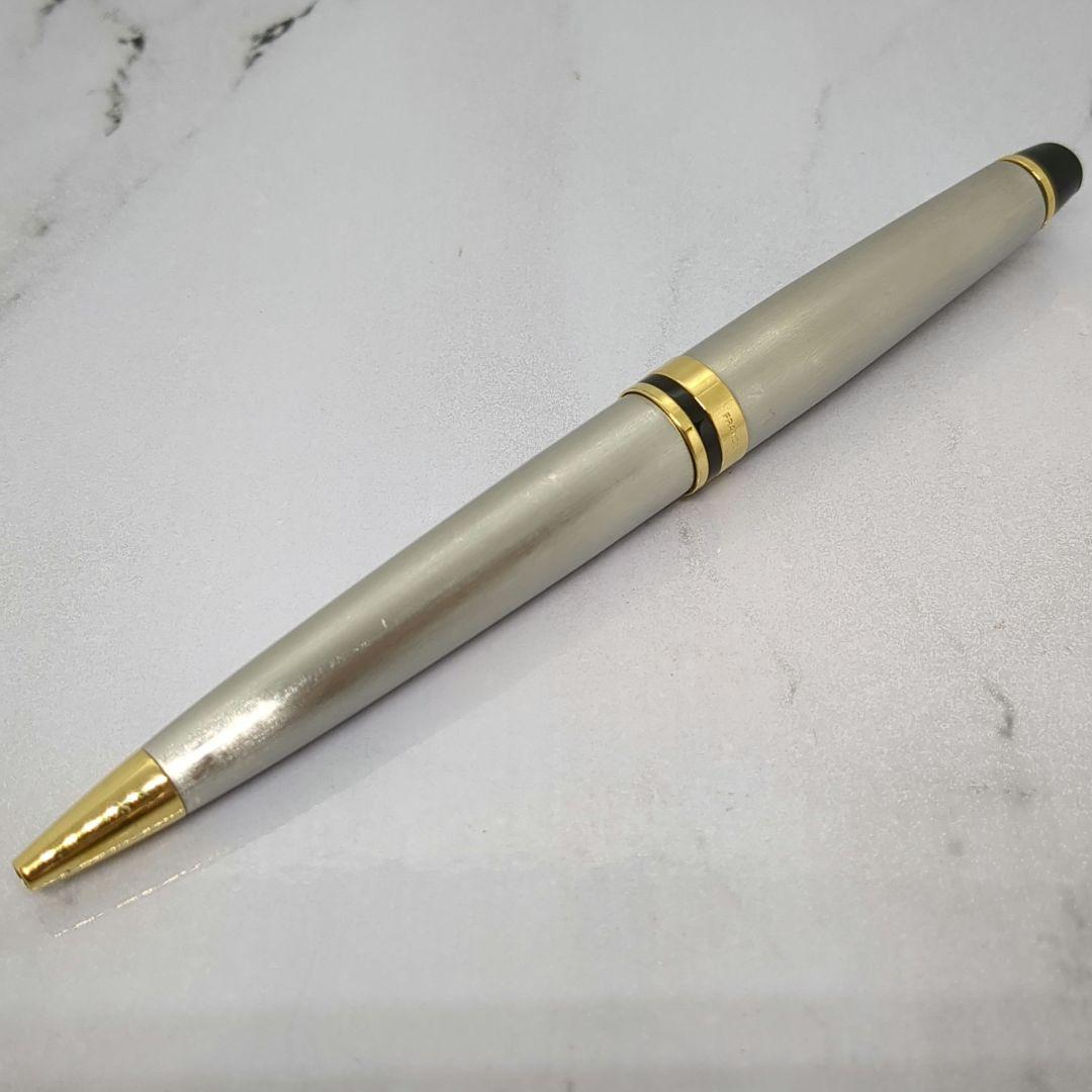 Waterman Expert ballpoint pen with steel satin finish and 23K gold trim, showing minor wear