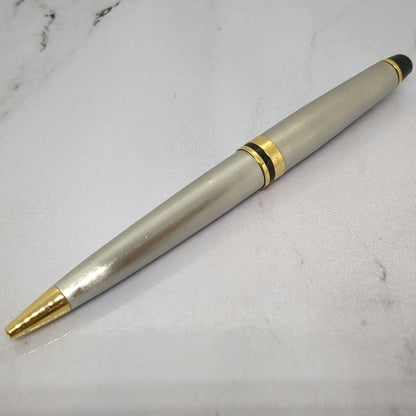Waterman Expert ballpoint pen with steel satin finish and 23K gold trim, showing minor wear