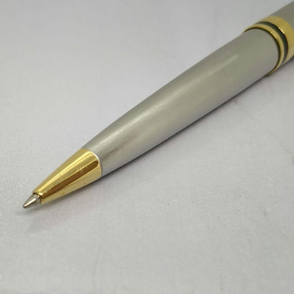 Waterman Expert ballpoint pen with steel satin finish and 23K gold trim, showing minor wear
