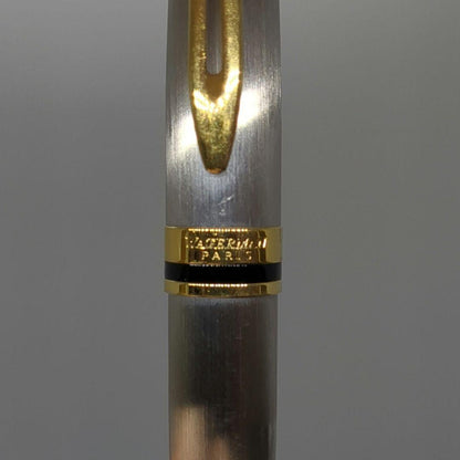 Waterman Expert ballpoint pen with steel satin finish and 23K gold trim, showing minor wear