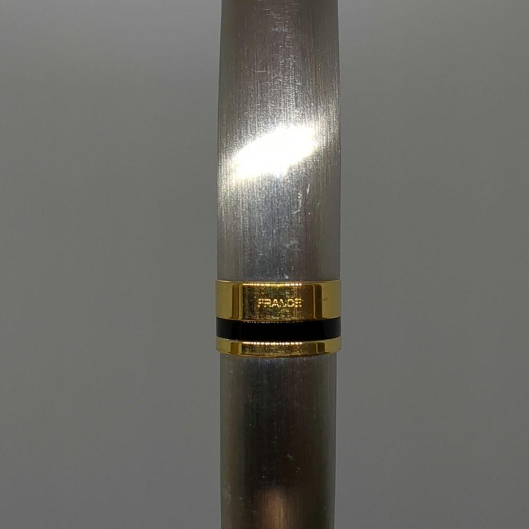 Waterman Expert ballpoint pen with steel satin finish and 23K gold trim, showing minor wear