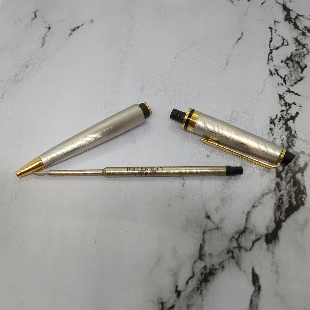 Waterman Expert ballpoint pen with steel satin finish and 23K gold trim, showing minor wear