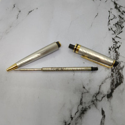 Waterman Expert ballpoint pen with steel satin finish and 23K gold trim, showing minor wear