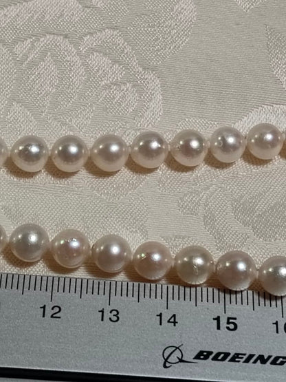 Akoya pearl necklace with white pearls 6.5-6.9 mm and silver push-insertion clasp on white background