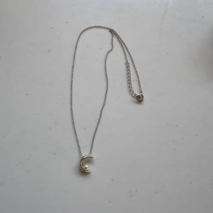 Tasaki Baby Pearl and Moon Necklace featuring silver moon pendant and lustrous pearls