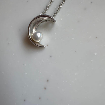 Tasaki Baby Pearl and Moon Necklace featuring silver moon pendant and lustrous pearls