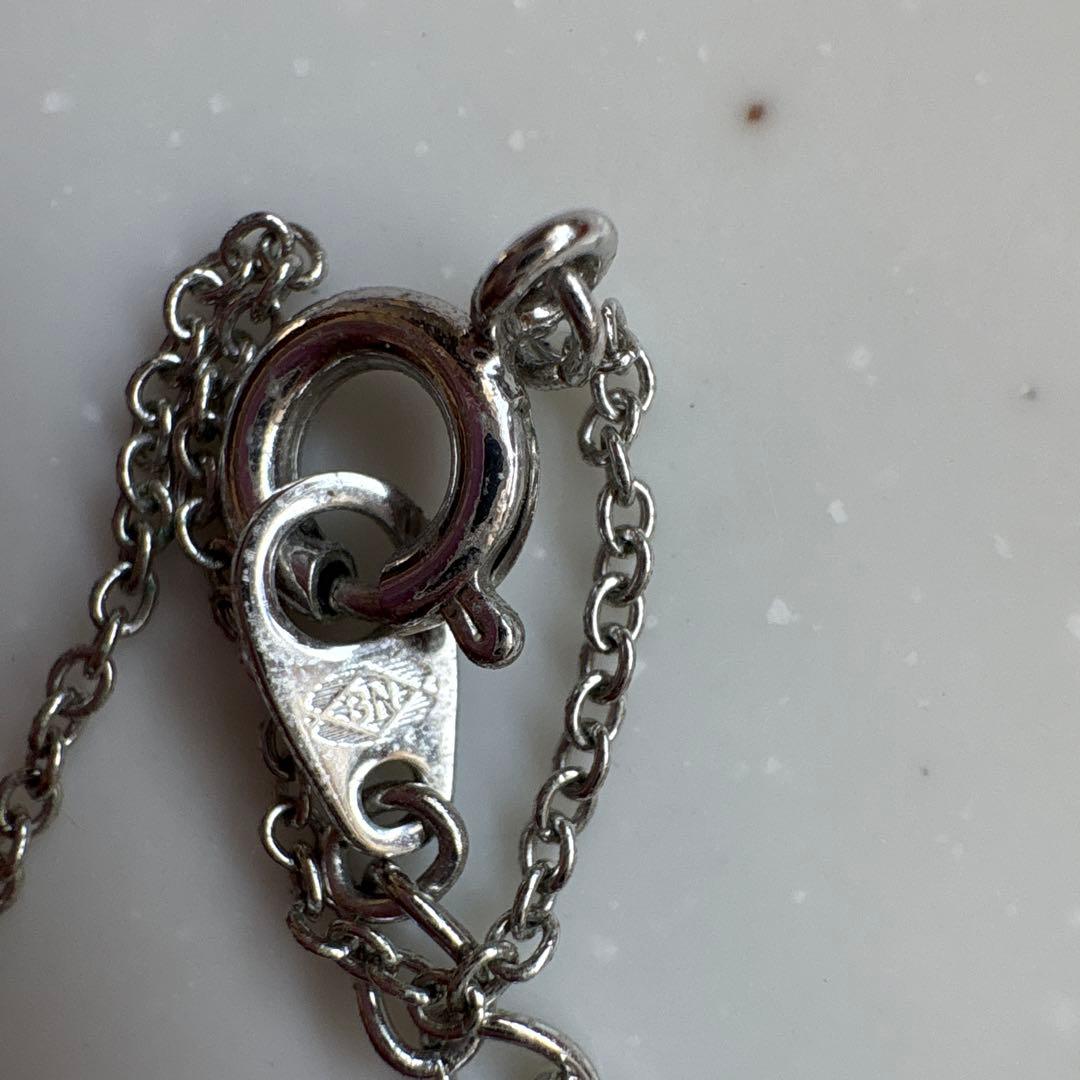 Tasaki Baby Pearl and Moon Necklace featuring silver moon pendant and lustrous pearls