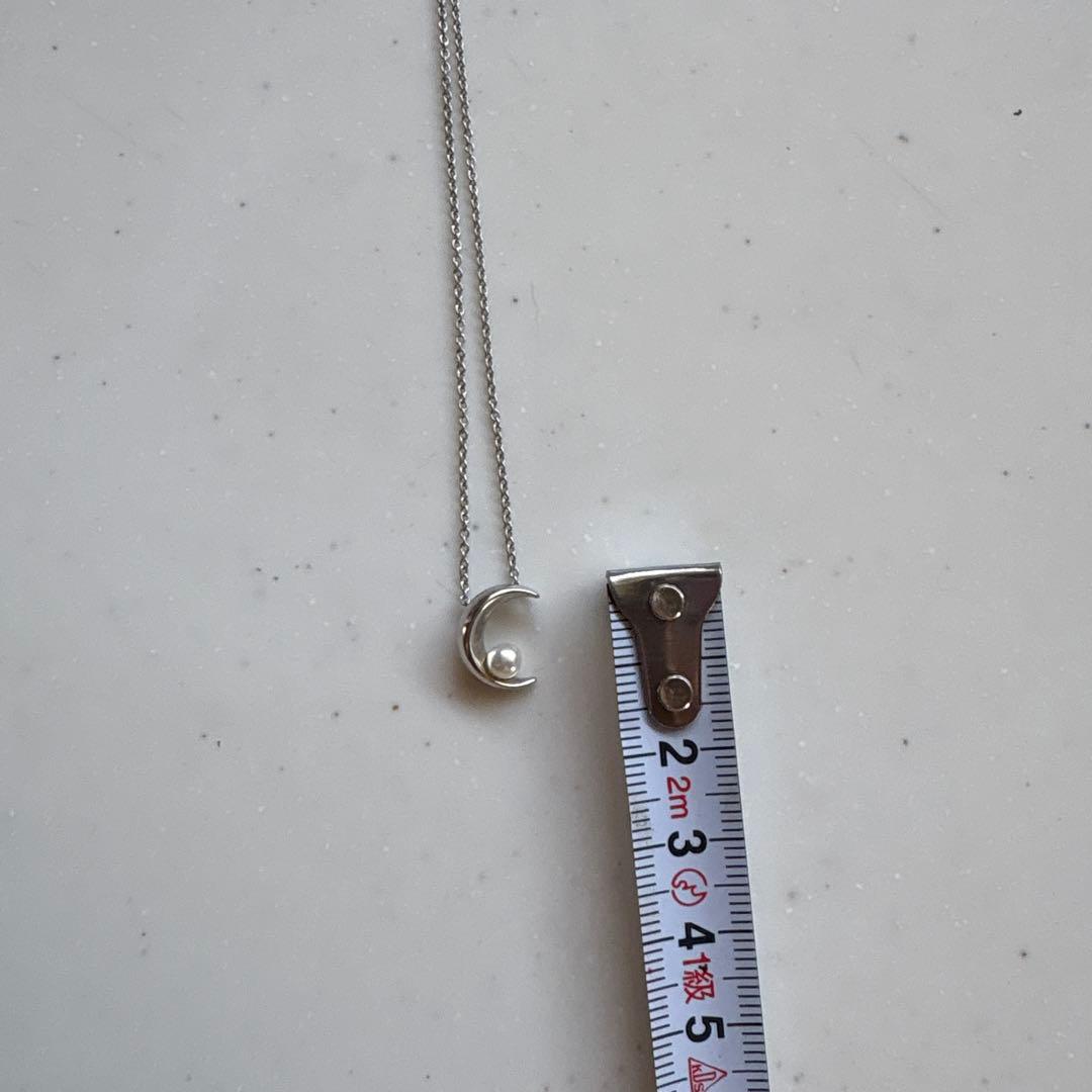 Tasaki Baby Pearl and Moon Necklace featuring silver moon pendant and lustrous pearls