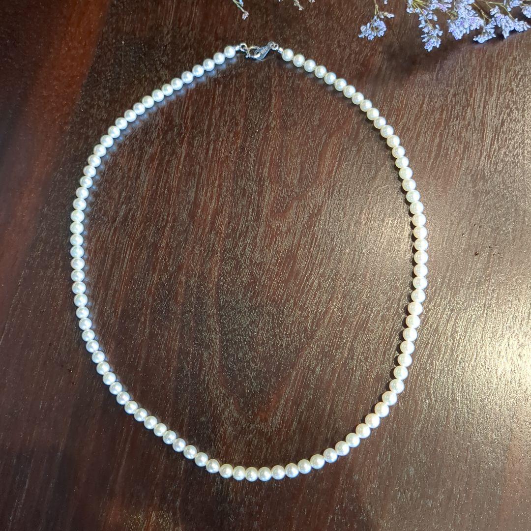 Vintage Pt850 Akoya pearl necklace with 5mm pearls and mint mark clasp on a white background