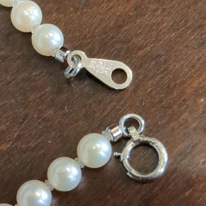 Vintage Pt850 Akoya pearl necklace with 5mm pearls and mint mark clasp on a white background