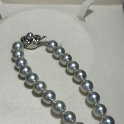 Tasaki Akoya pearl necklace with 8.5-9.0mm pearls and silver clasp on a white background