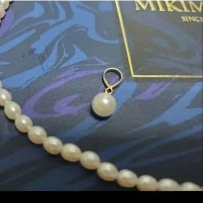 MIKIMOTO K18 pearl necklace with 5mm pearls and updated replacement thread, shown on white background
