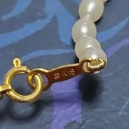 MIKIMOTO K18 pearl necklace with 5mm pearls and updated replacement thread, shown on white background
