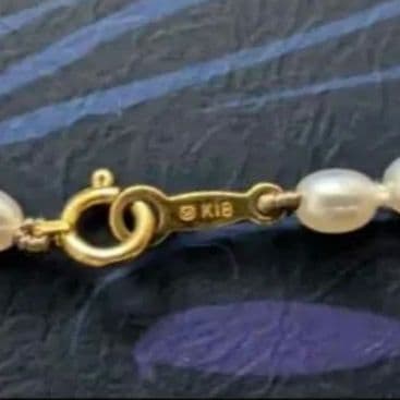 MIKIMOTO K18 pearl necklace with 5mm pearls and updated replacement thread, shown on white background