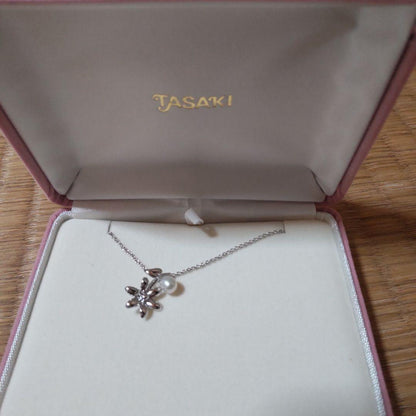 TASAKI Freshwater Pearl Necklace featuring silver flower motif and round white pearls