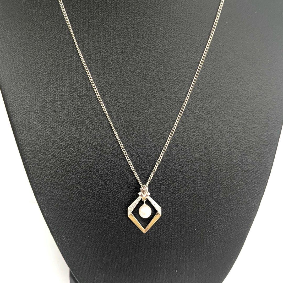 Mikimoto necklace with silver diamond-shaped pendant and glossy white pearl hanging on a 42cm silver chain