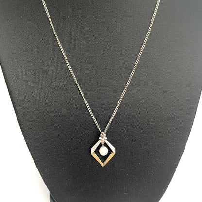 Mikimoto necklace with silver diamond-shaped pendant and glossy white pearl hanging on a 42cm silver chain
