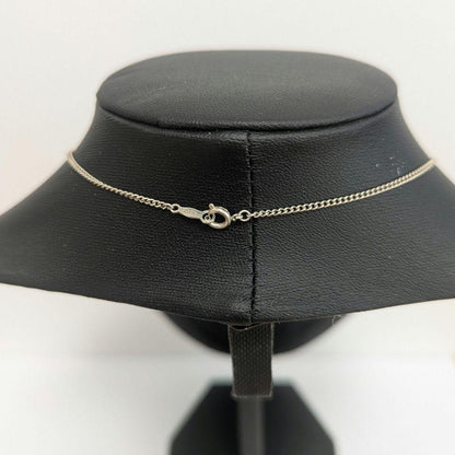 Mikimoto necklace with silver diamond-shaped pendant and glossy white pearl hanging on a 42cm silver chain