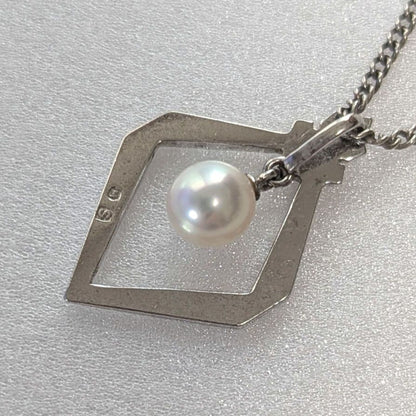 Mikimoto necklace with silver diamond-shaped pendant and glossy white pearl hanging on a 42cm silver chain