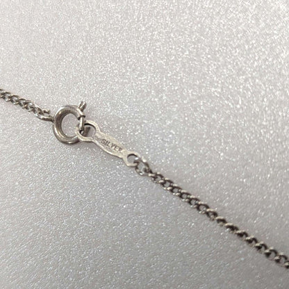 Mikimoto necklace with silver diamond-shaped pendant and glossy white pearl hanging on a 42cm silver chain