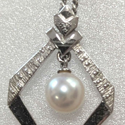 Mikimoto necklace with silver diamond-shaped pendant and glossy white pearl hanging on a 42cm silver chain