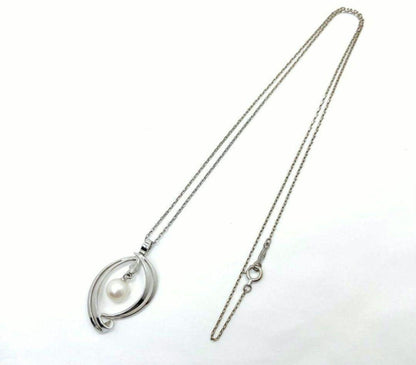 Set of four including Mikimoto silver pearl necklace, Nina Ricci necklace, Nina Ricci handkerchief, and cosmetic item